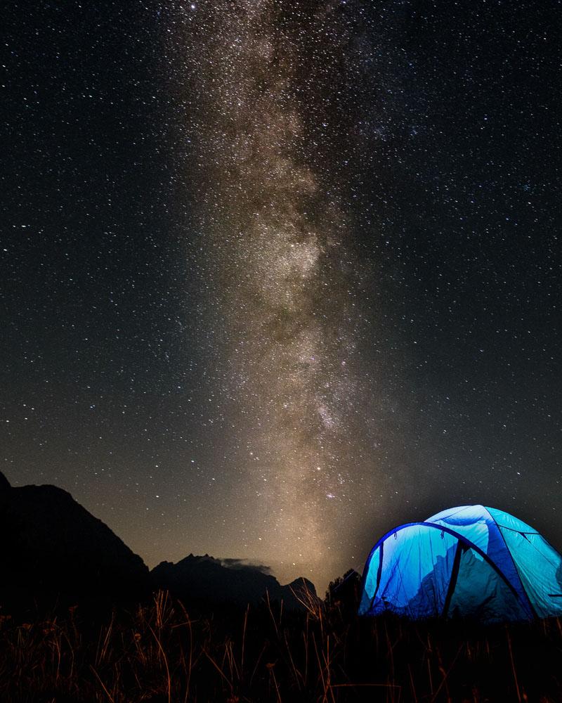 a blue 4 person tent with porch under the stars