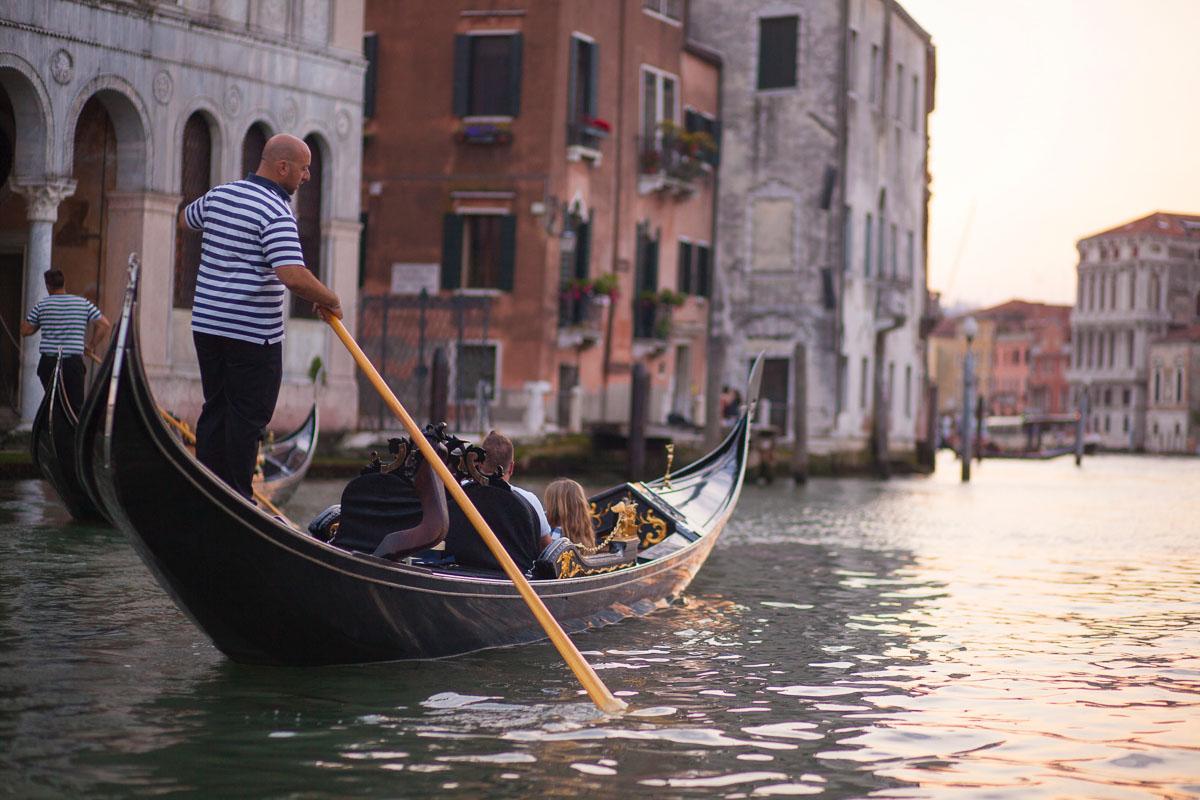 a gondolier and his black gondola in venice