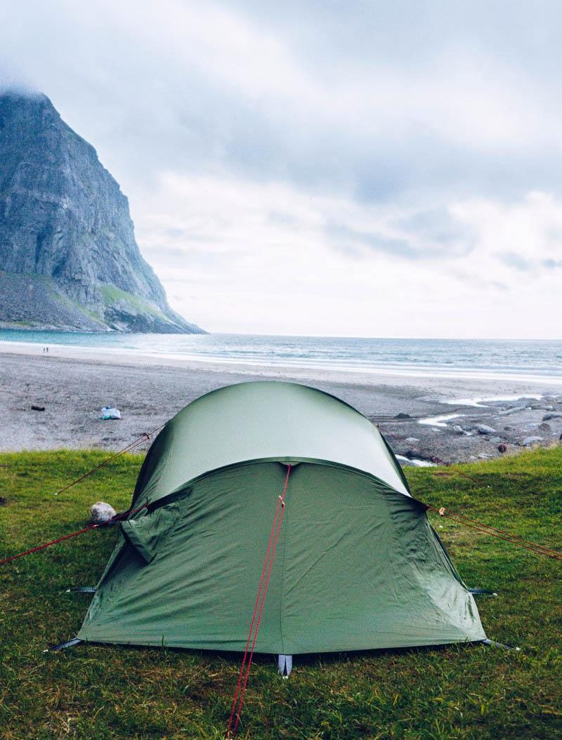 a green tunnel tent 4 person on the beach