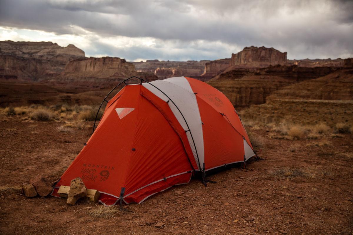 a red pop up tunnel tent in the mountain