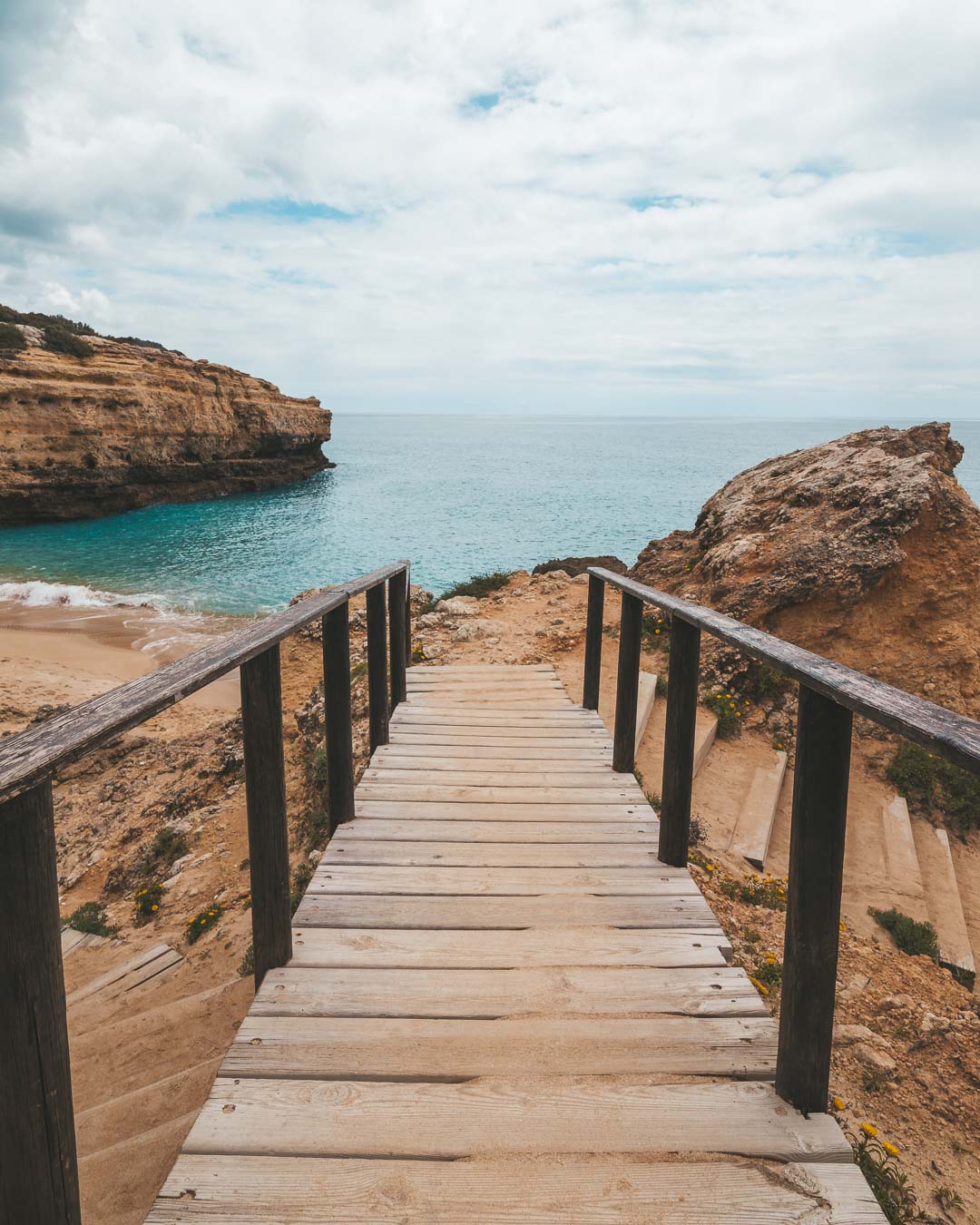 Wooden staircase to albandeira beach
