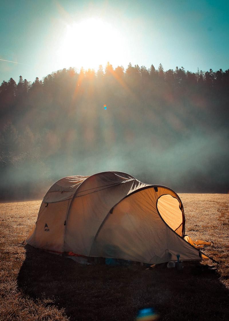 an 8 person tunnel tent under the morning mist