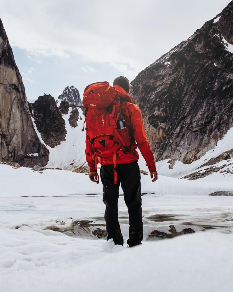 backpacker in snow preparing to camp in his 6 man 4 season tent