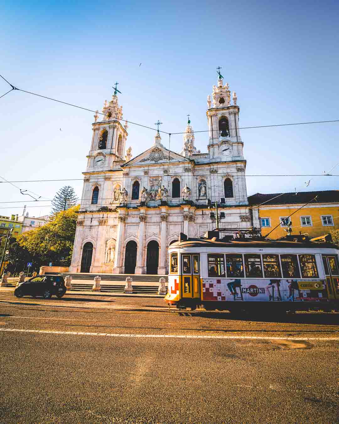 yellow tram in front of basilica da estrela