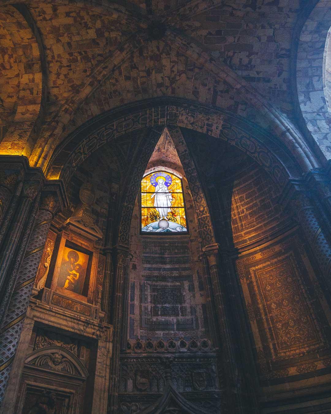 detail of stained glass window in avila cathedral spain