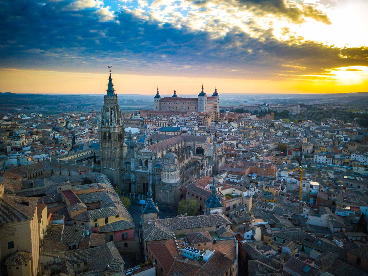 the sun rising over toledo and the toledo cathedral