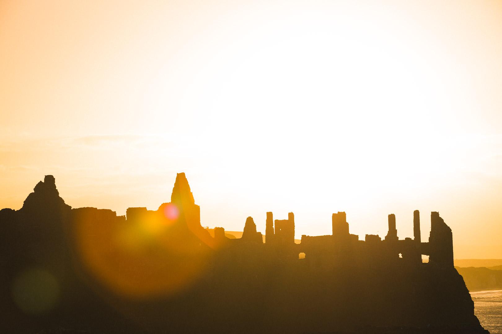 warm light over the castle of dunluce castle