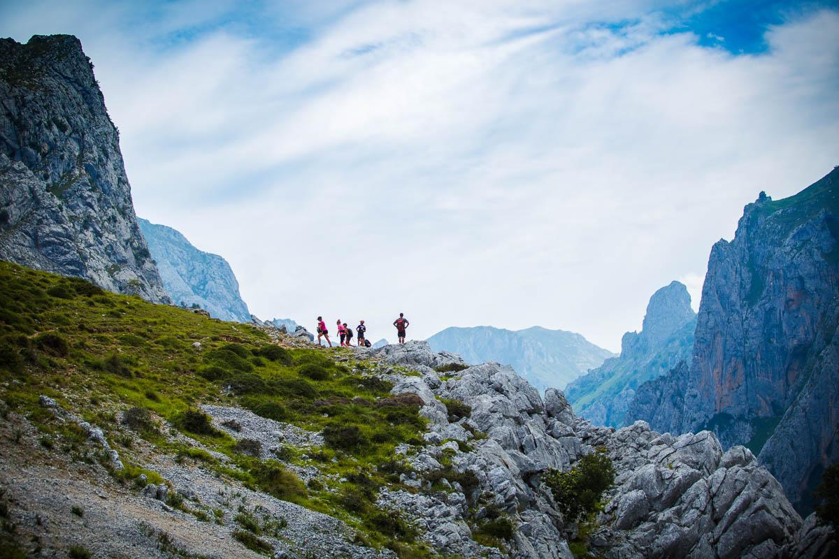 hikers in front of the massive mountains in picos de europa ruta del cares