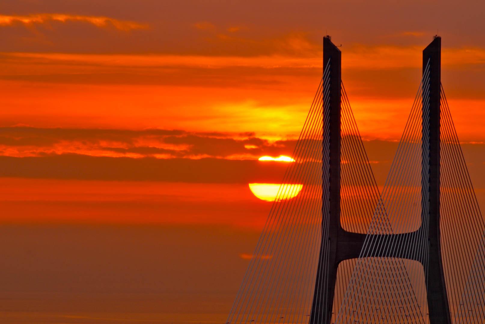 lisbon sunset over ponte vasco da gama