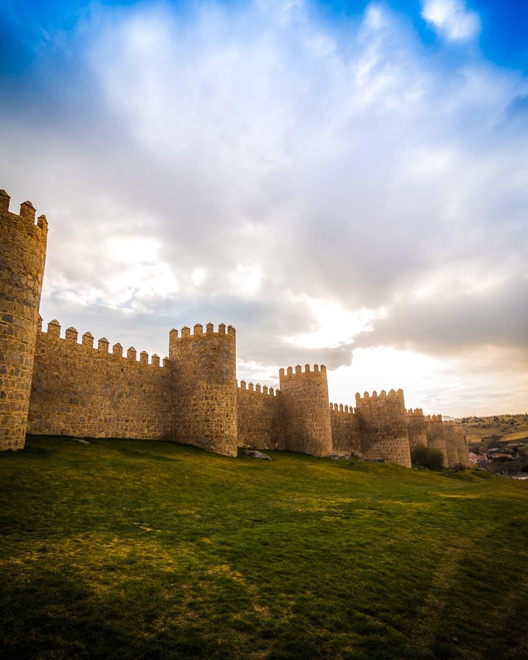 stormy sky over the walls of avila spain