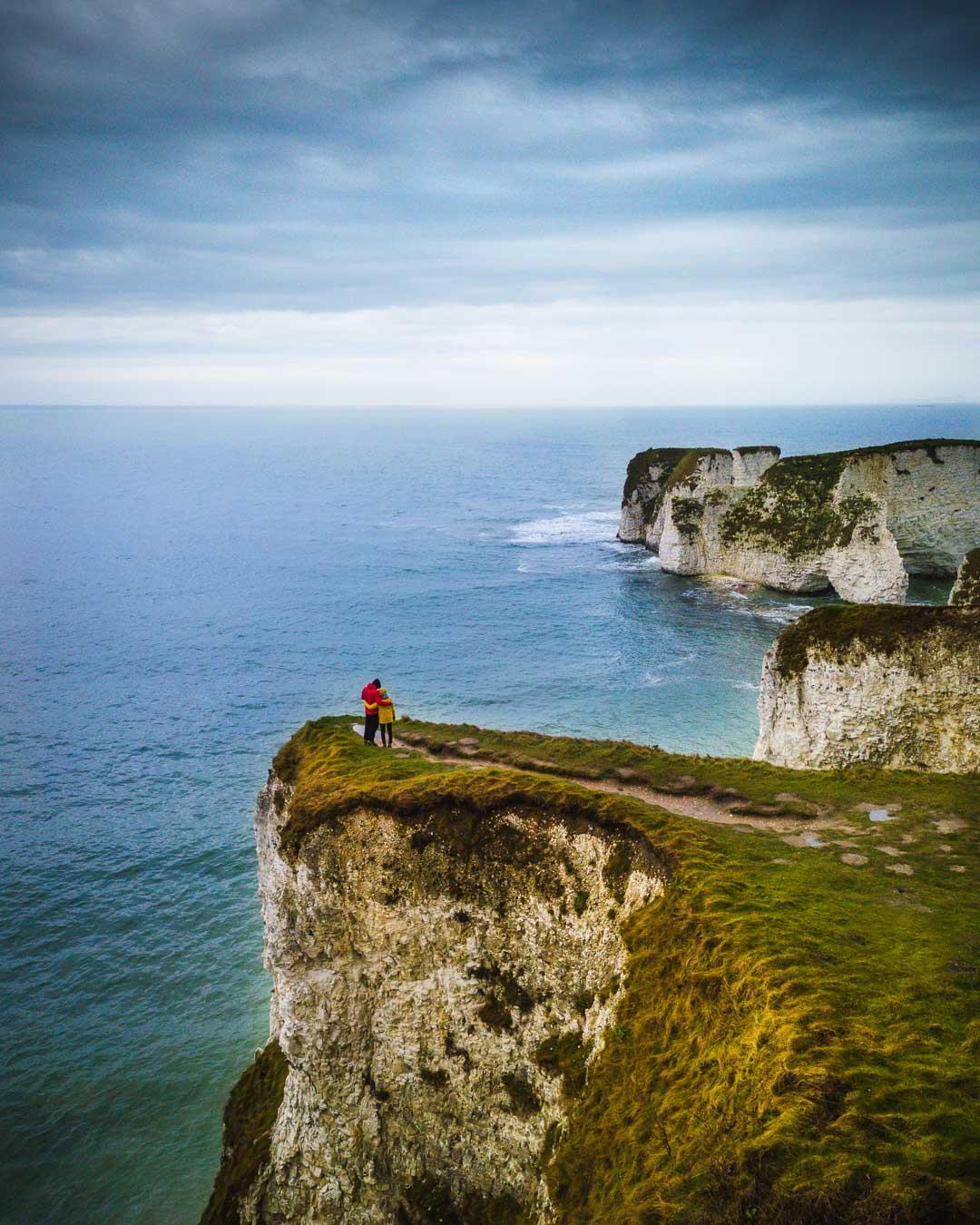 couple on cliff at old harry rocks