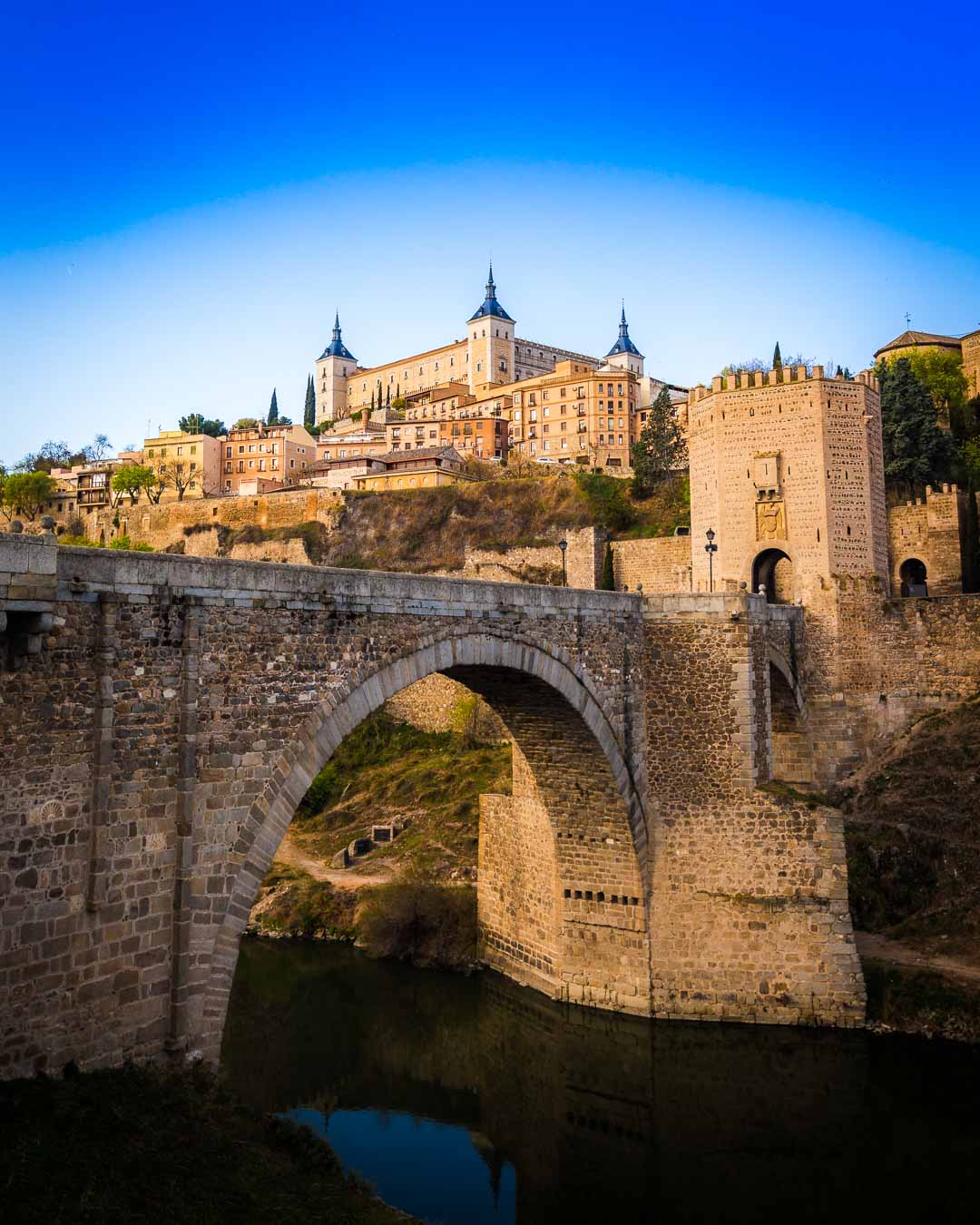 the puente alcantara toledo as seen after taking the train from madrid to toledo