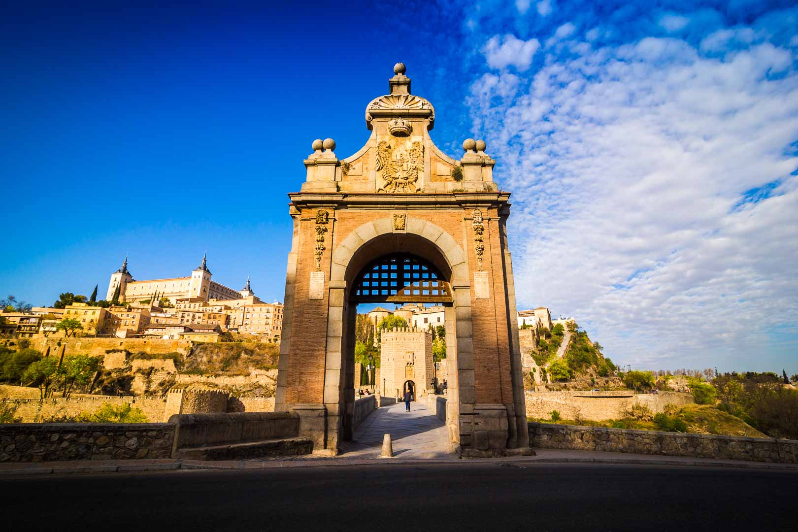 standing in front of the east entrance of the puente de alcantara