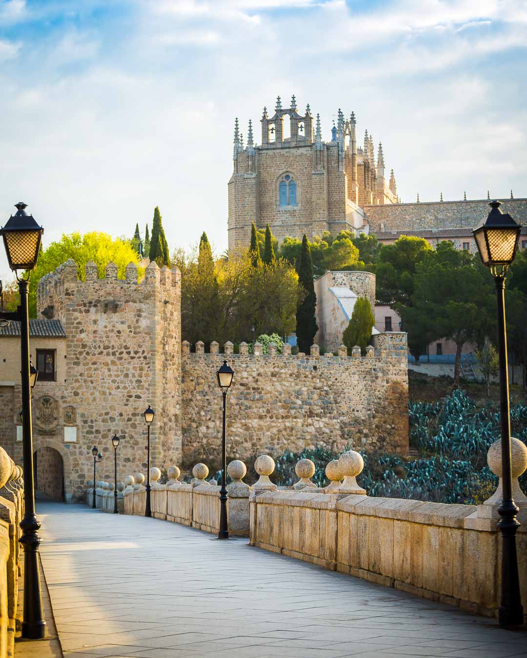 puente san martin toledo with the monastery san juan de los reyes in the back in vertical version