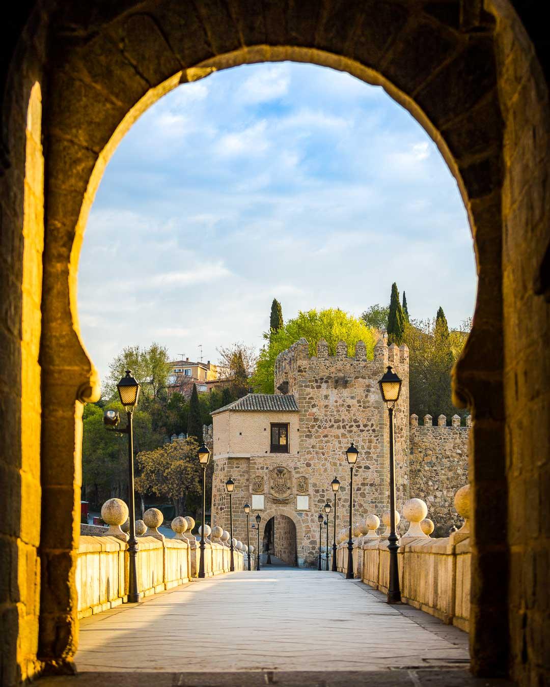 starting the free walking tour toledo spain on the puente de san martin