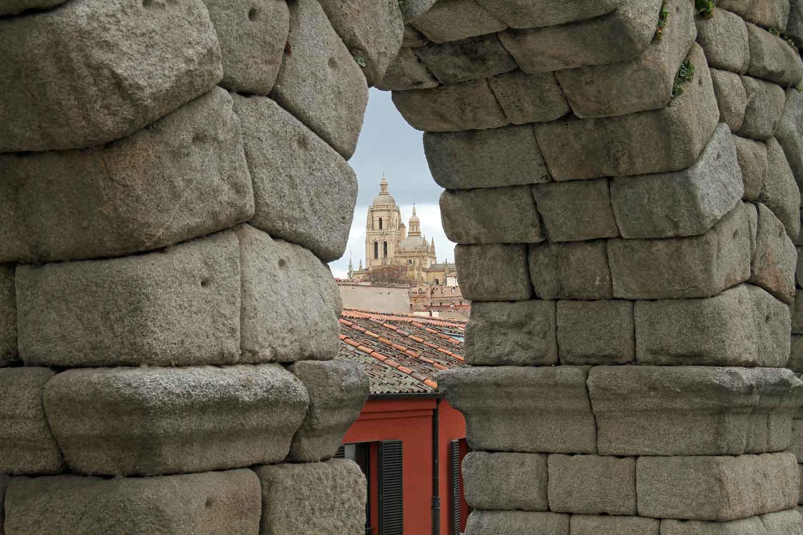 the segovia cathedral as seen through the aqueduct