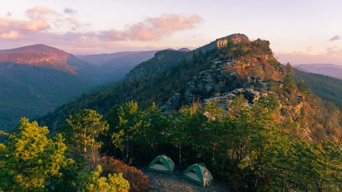 two green 4 man tents 2 rooms in the mountain