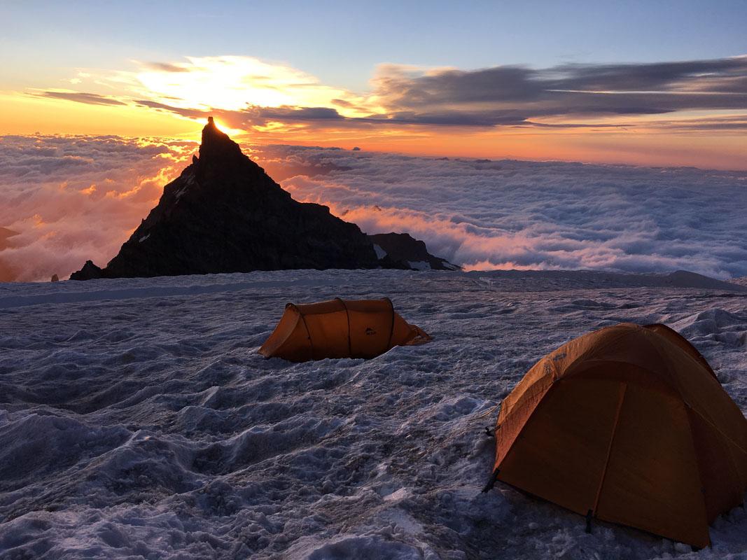 two orange best 4 person camping tents in the snow in the mountain