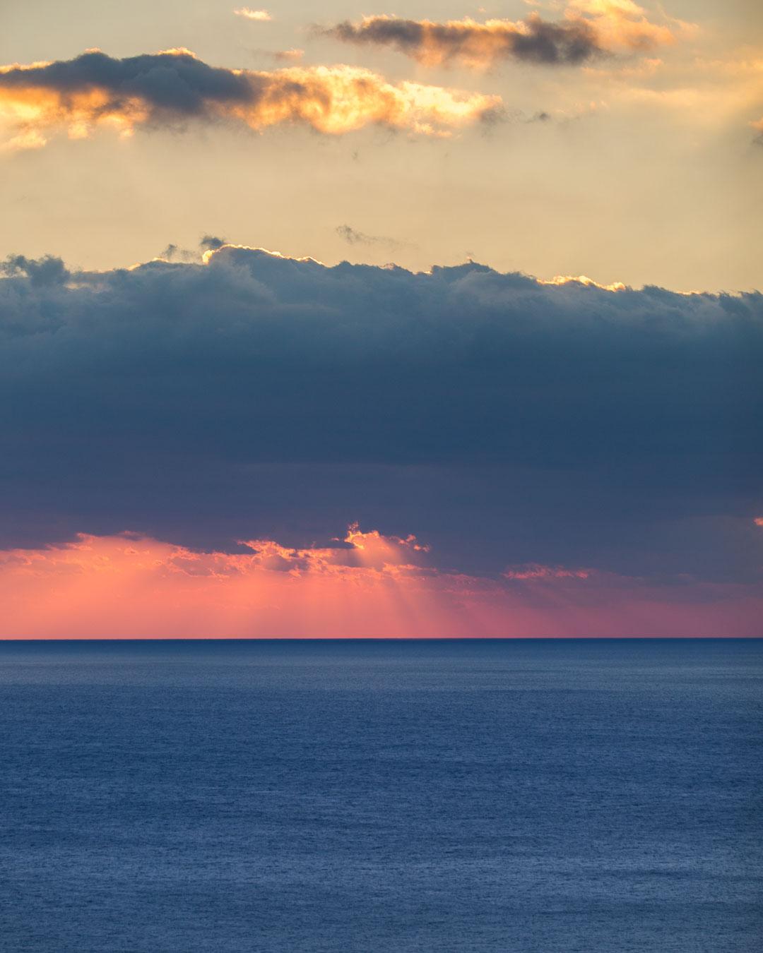 sun setting over the sea next to vernazza