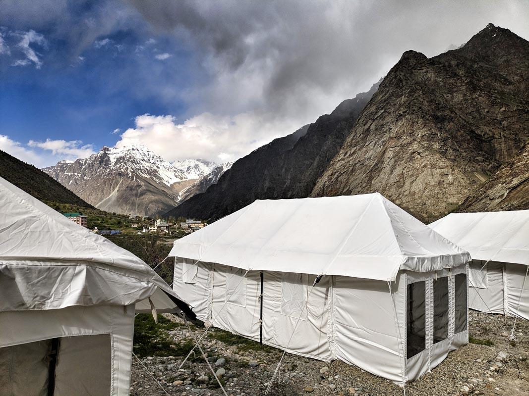 white tall camping tents in the mountain