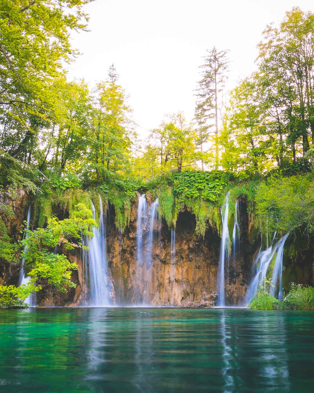 quintuple waterfall over a lake in plitvice