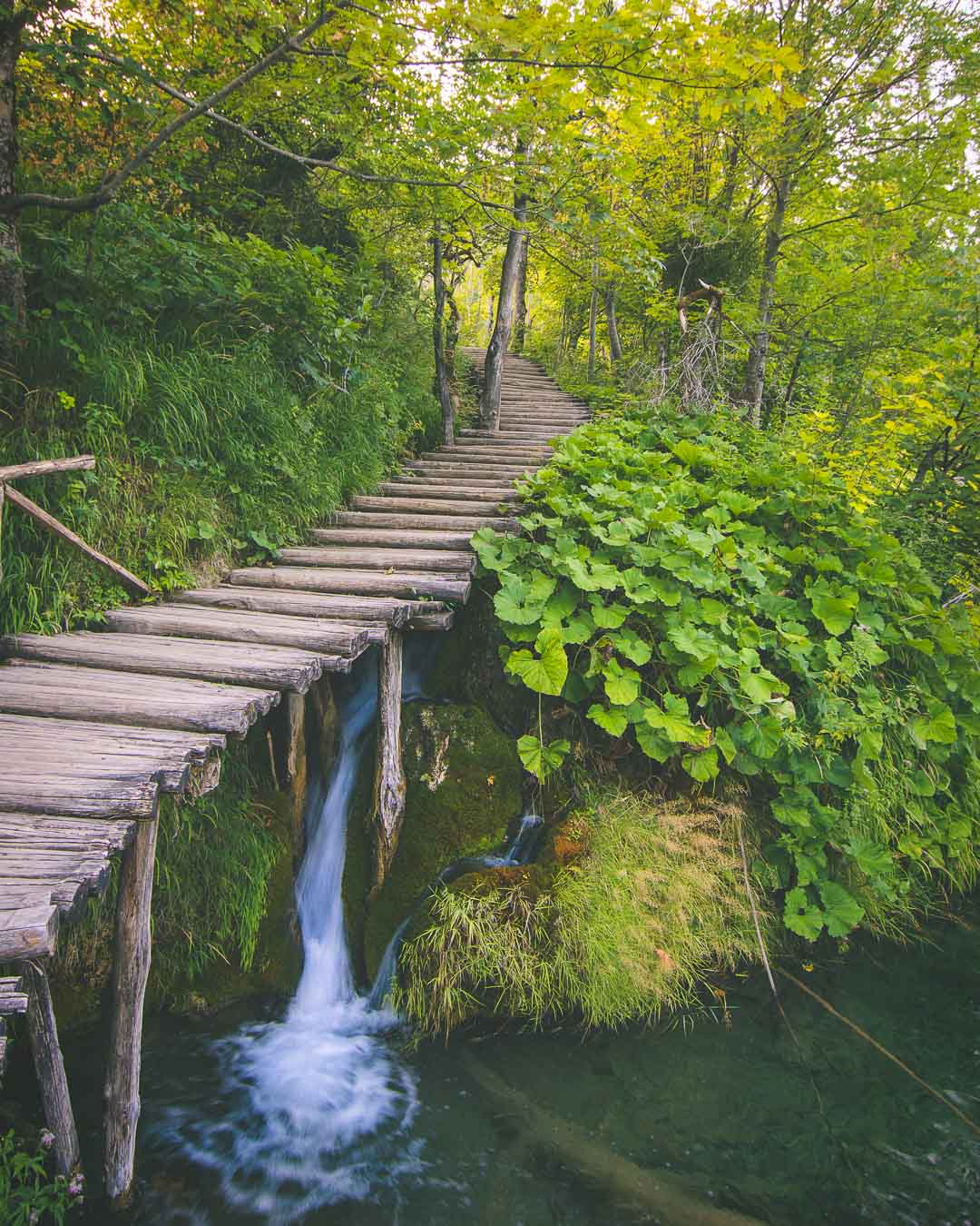 wooden path over waterfall in plitvice