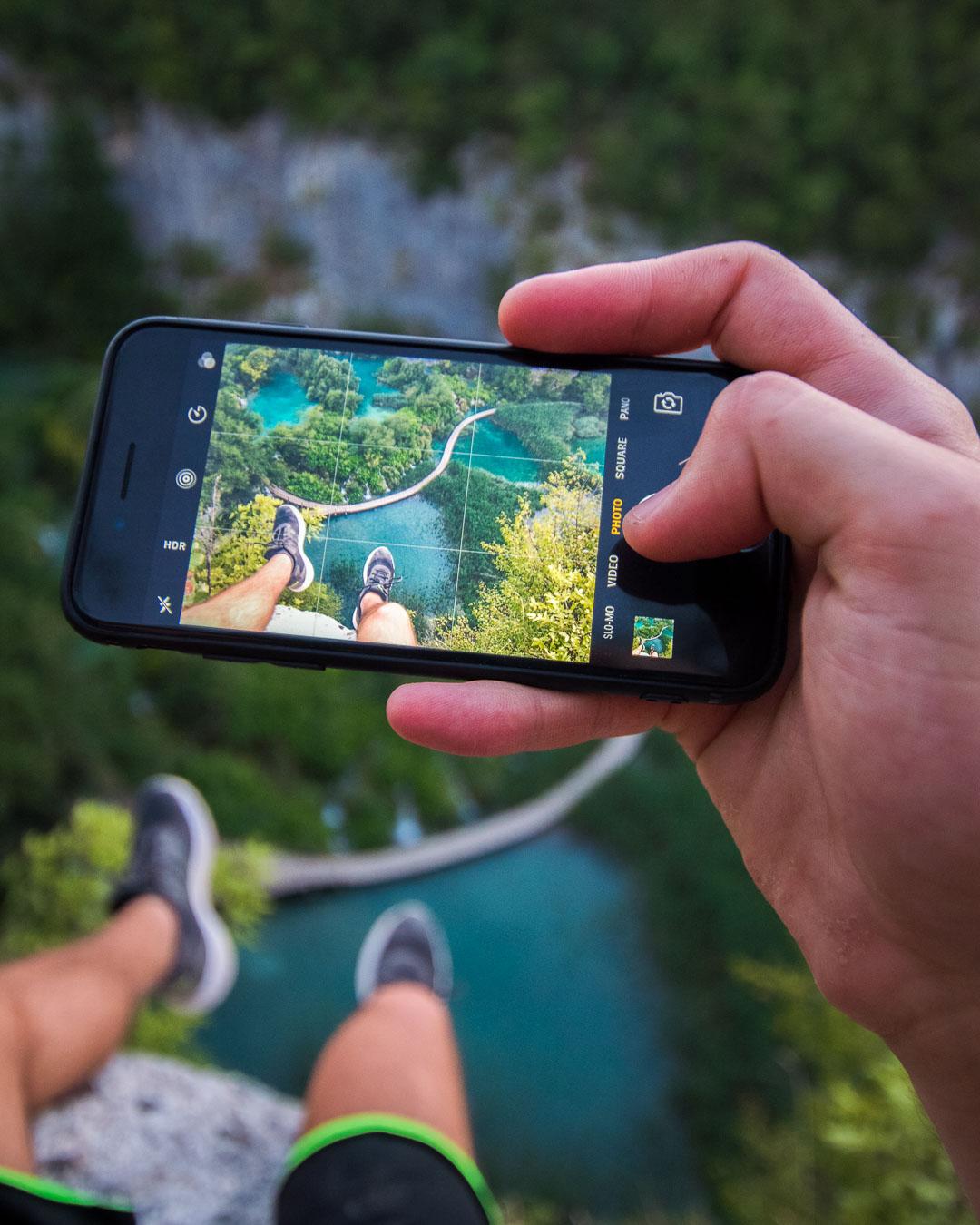 pathway over plitvice lakes from above through a phone