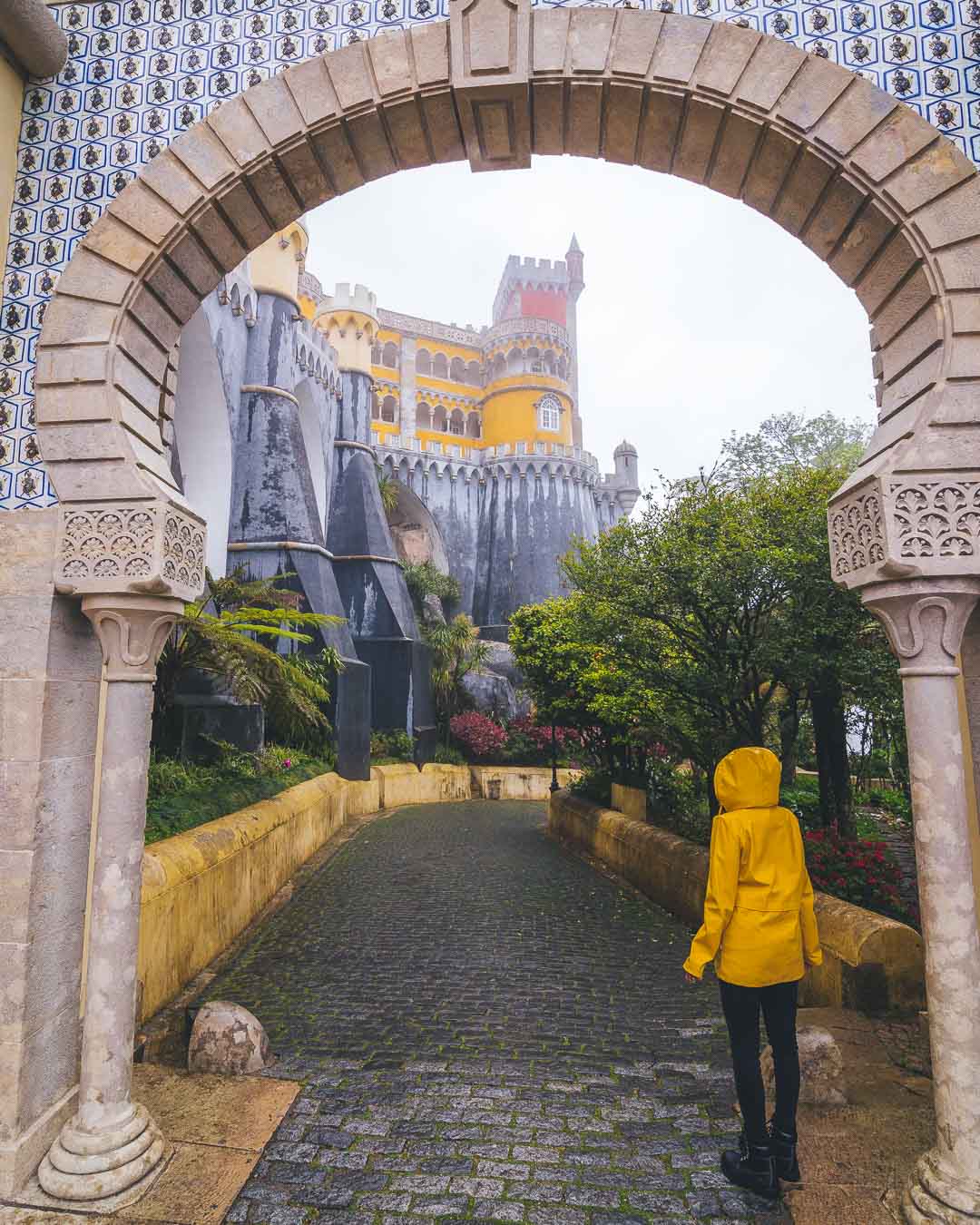 nesrine standing under the arch in front of pena palace