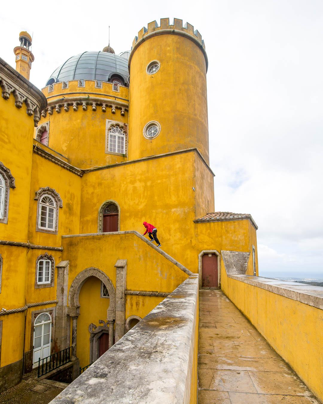 me climbing the yellow buildings of palacio da pena