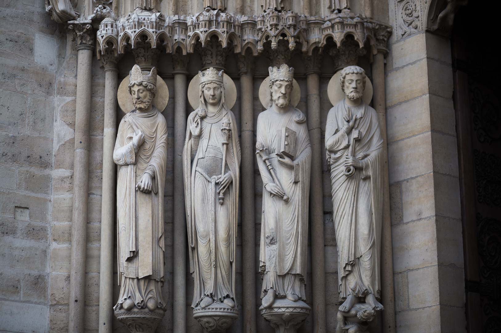 statue on the facade of notre dame de paris