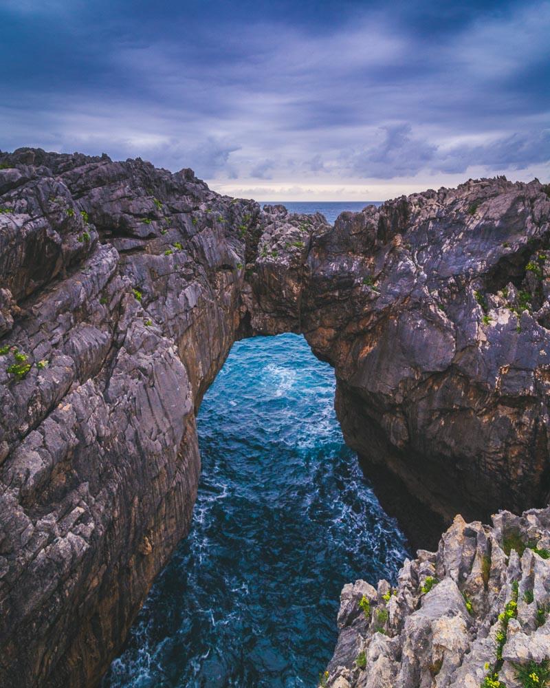 vertical version of natural bridge over the sea