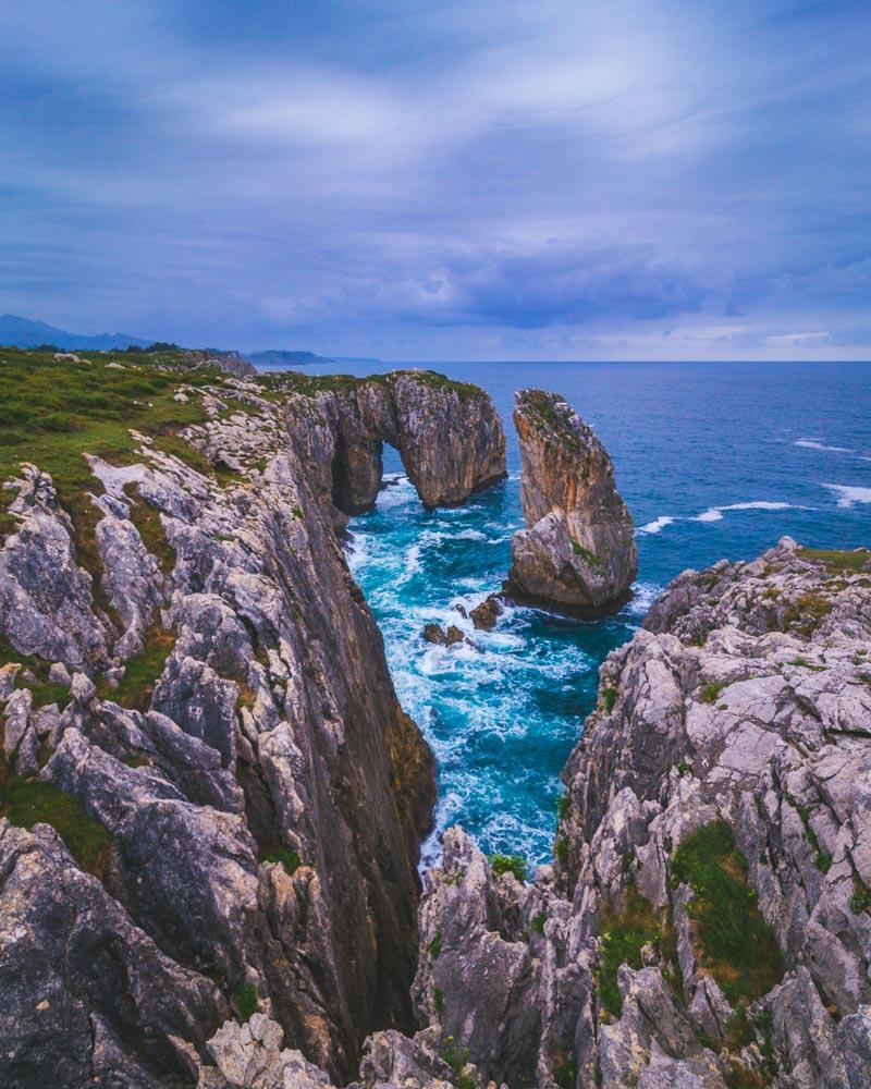 vertical version of massive rock in the sea in bufones de pria