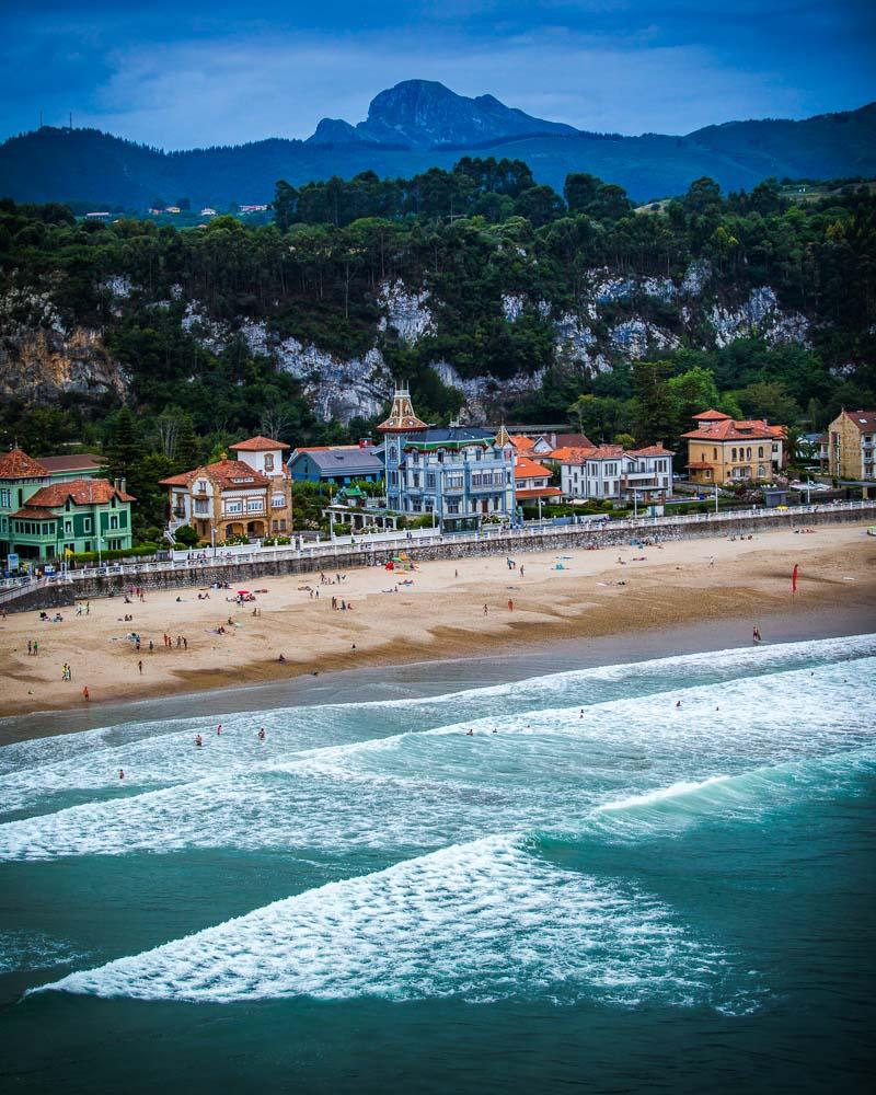 surfers in the water at playa de santa marina