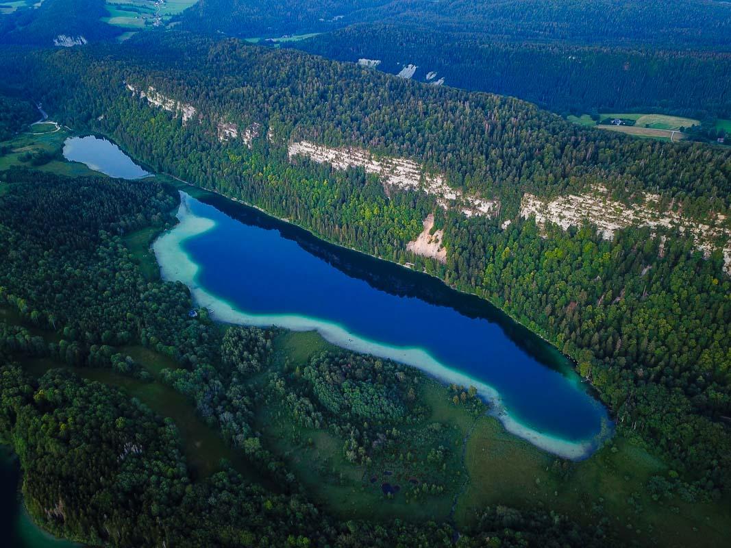 le grand maclu and le petit maclu lakes in front of the belvedere des quatre lacs jura