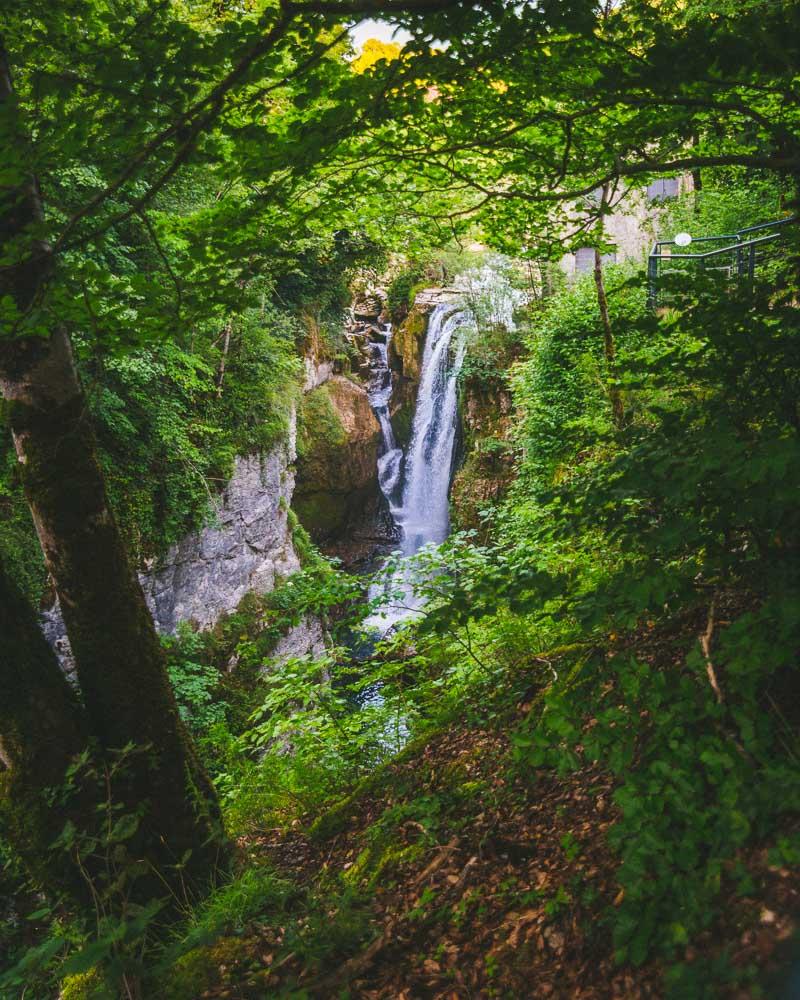 Small forest waterfall in Gorges de la Jogne river canyon in Broc