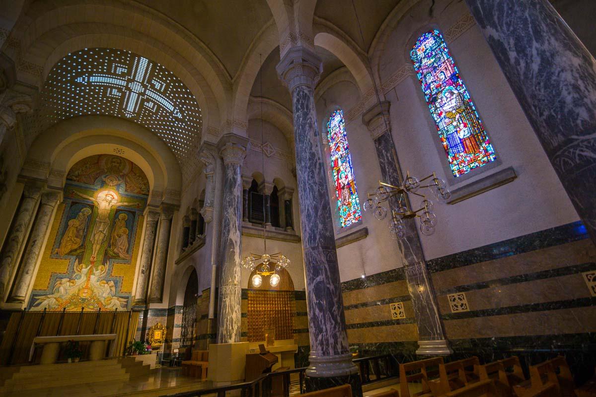 altar and stained glass window in basilica of the visitation