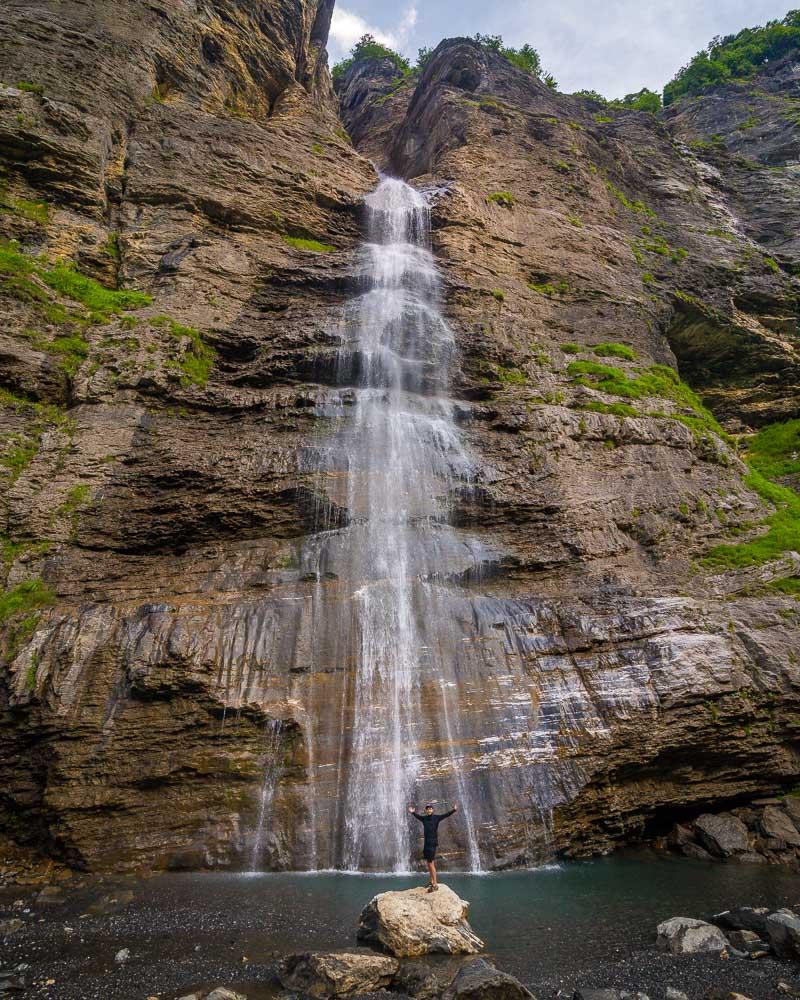 kevmrc below a waterfall on the randonnee du bout du monde hike