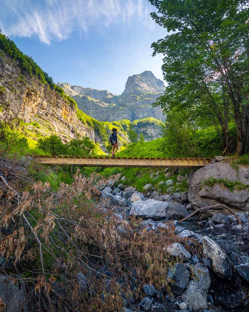 nesrine crossing a wooden bridge