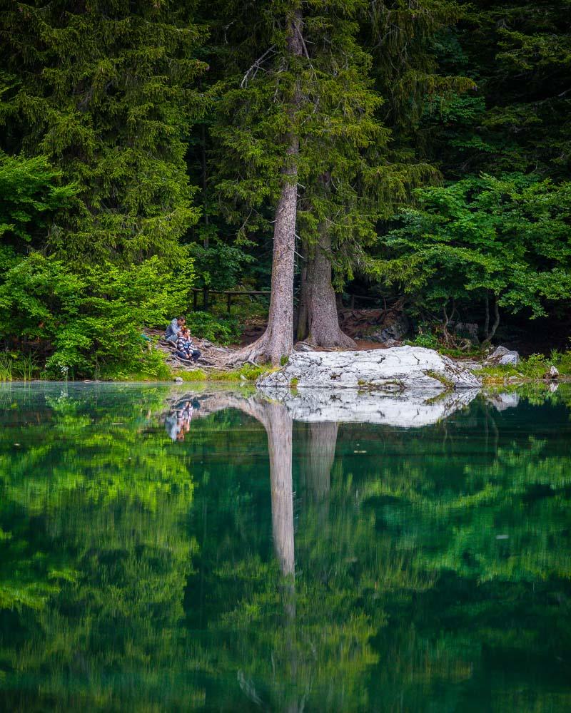 couple chilling on the shore of lac vert