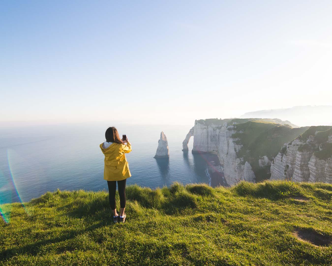 nesrine taking a photo of the cliffs of etretat