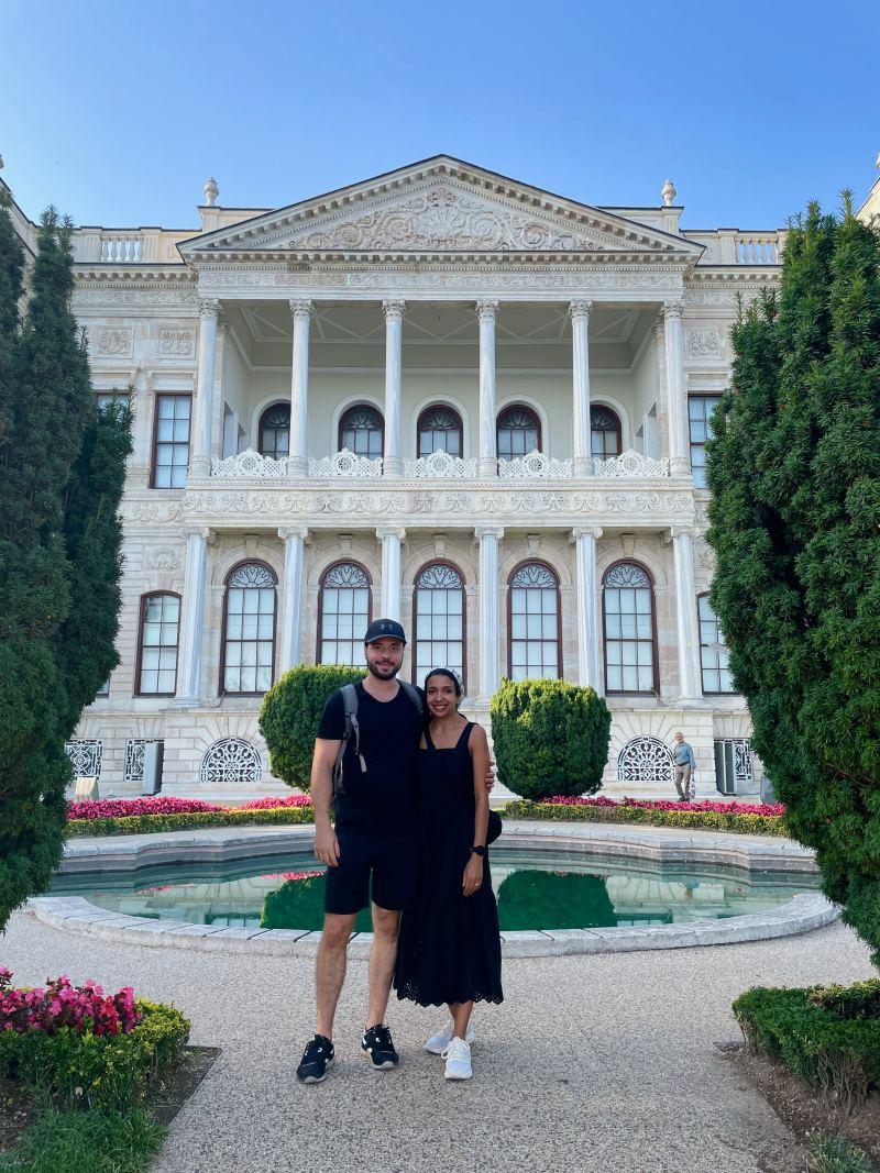 posing in front of dolmabahce palace